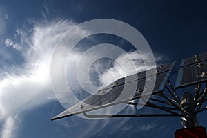 Solar panels in front of cirrus clouds photo