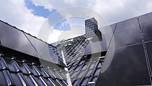 Solar panels on a gable roof shown in a crane shot