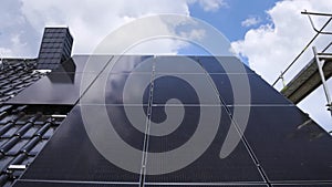 Solar panels on a gable roof shown in a panning shot