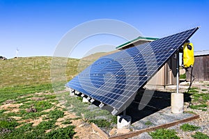 Solar panels on green hills