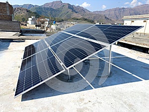 Solar panels on a house roof in Pakistan by generating clean and renewable energy