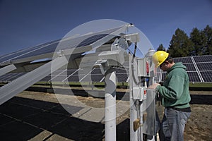Solar panels inspected by workman photo
