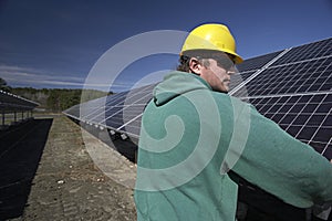 Solar panels inspected by workman photo