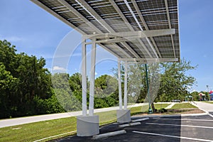 Solar panels installed over parking lot canopy shade for parked cars for effective generation of clean energy