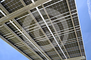 Solar panels installed over parking lot canopy shade for parked cars for effective generation of clean energy