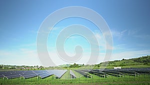 Solar panels in a mountainous area near the road. Around the fence with barbed wire. Modern technologies.