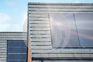 Solar panels mounted on the roof of a modern new-build house in England UK