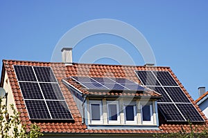 Solar panels on an older residential building roof.