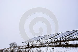 Solar panels Photocells on a gloomy foggy frosty winter day in the countryside.