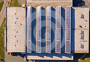 Solar panels or photovoltaic plant on the roof of a factory building