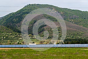 Solar panels, photovoltaics, alternative electricity source. View of a solar station at the foothills of a mountain