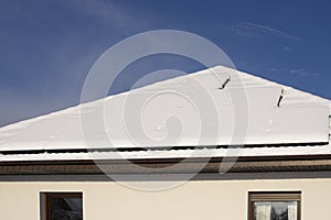 Solar panels on a private house covered with snow