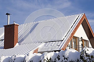 Solar panels on a private house covered with snow