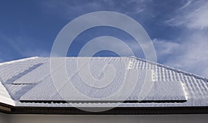 Solar panels on a private house covered with snow