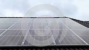 Solar panels producing clean energy on a roof of a residential house