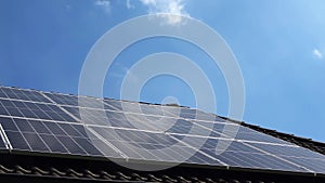 Solar panels producing clean energy on a roof of a residential house