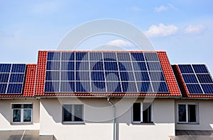 solar panels or PV cells on sloped clay house roof.