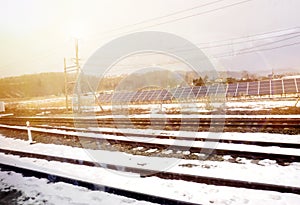 Solar panels beside railroad with snow on the way outlying district of Supporo city to Hakodate city