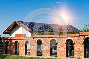 Solar panels on a red tiled roof, home installation -  alternative electricity source,  concept of sustainable resources-