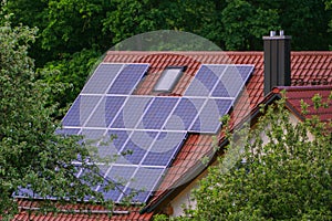 Solar panels on rood of modern resiadental house, renewable energy system.