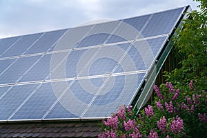Solar panels on rood of modern resiadental house, renewable energy system.