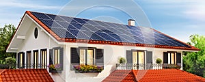 Solar panels on the red roof of a beautiful house and clear sky photo