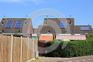 Solar panels on the roof of the houses in the summer.