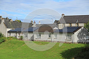 Solar panels on the roof of the houses in the summer.