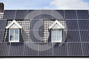 Solar panels on a roof with two dormers