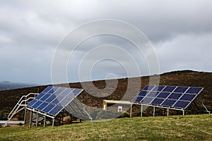 Solar panels situated on a hill photo