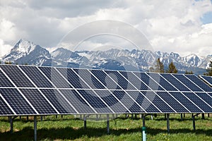 Solar panels with snowy mountains in the background