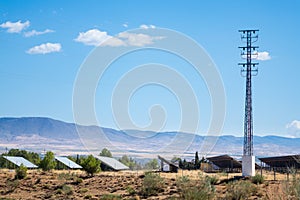 Solar panels in sun under mountains