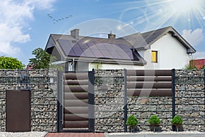 Solar panels on the tiled roof of the building in the sun photo