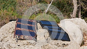 Solar panels for tourism lie on a rock under the sun.