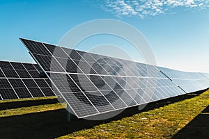 solar panels under blue sky, in solar photovoltaic plant