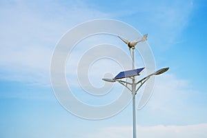 Solar panels and wind turbine and blue sky background