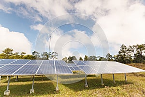 Solar panels and wind turbine in contryside.