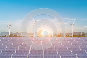 Solar panels with wind turbines against blue sky background