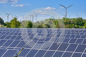 Solar panels with wind turbines in the back