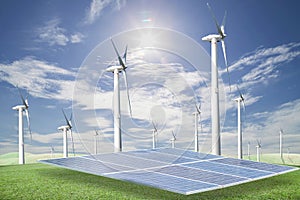 Solar panels,wind turbines on green grass with blue sky background,natural Energy.