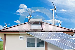 Solar panels,wind turbines on green grass with blue sky background,natural Energy.