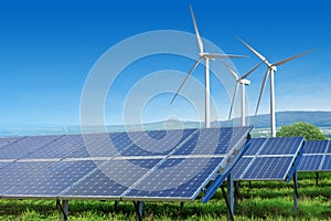 Solar panels and wind turbines under blue sky