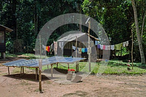 Solar panels in the yard next to the African hut (Republic of the Congo) photo