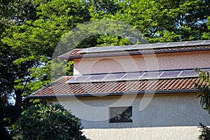 Solar photovoltaic panels installed on a tiled roof for alternative energy