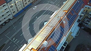 Solar photovoltaic panels mounted on roof of swedish condo building in Linkoping residential area. Renewable electricity