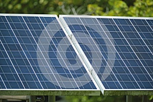 Solar photovoltaic panels mounted on stand-alone frame on backyard ground for generating of clean ecological electric