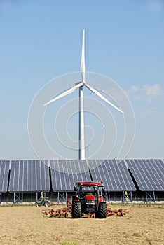 Solar plant with wind turbine at farm photo