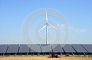 Solar plant with wind turbine at a farm photo