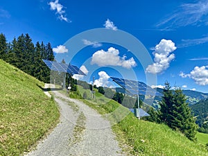 Solar power panels in front of a eco-friendly mountain resort in Saalbach-Hinterglemm in the Austrian alps as renewable photo