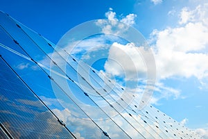 Solar power panels and natural landscape in sunny summer
